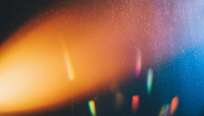 Wall Mural - blur colorful warm rainbow light leaks on black background with dust texture. defocused abstract dam