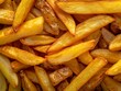 A close-up view highlighting the texture and color of freshly cooked french fries.
