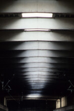 Vertical Image Of Sky Lights In Roof Space. Natural Sunlight White Blurry Pattern. Black Wall Space. Two Small Window Embrasures With Back Lighting. Location Euston Railway Station London UK 2003