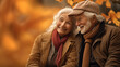 © Katewaree - Happy Retired Elderly couple sitting amidst a pile of colorful autumn leaves and the simple pleasures