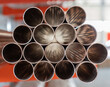 Pipes stack, straight copper. Industrial pieces of pipelines for conduit, factory or construction works
