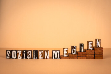 Wall Mural - Social Media text in German. Wooden alphabet letters on a light background