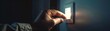 © kitidach - Closeup of a hand switching off a modern light switch, dark room gradually fading to black, ideal for home automation system ads