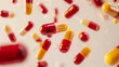 A high-quality photograph capturing red and yellow medicine capsules gracefully falling down against a light white studio background. The capsules are depicted mid-air, creating a dynamic and visually