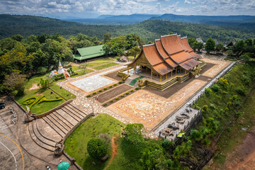 The aerial top view of Wat Sirindhorn Wararam or Wat Phu Prao, also known as the Glow Temple, is located in Sirindhorn, Ubon Ratchathani