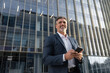 © Stock 4 You - Successful mature hispanic senior business man using smartphone cellphone financial application. Indian or latin confident middle age male entrepreneur businessman holding mobile cell phone for invest