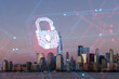 Manhattan skyline with digital hologram of a security padlock, concept of cybersecurity in an urban cityscape, during twilight. Double exposure