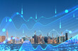 New York City skyline overlaid with futuristic digital graphs, illustration, against a blue sky. Technology and business concept. Double exposure