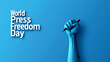 Word press freedom day concept with raised fist holding  pen isolated on blue background 