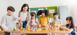 Portrait of asian caucasian little children playing blocks in classroom. Learning by playing education group study concept. International pupils doing activities brain training in primary school.