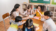 Pupils group study with teacher in classroom at elementary school. Students group study in primary school. Children learn activities in classroom. Education knowledge successful teamwork banner