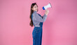 Portrait of young fun smart happy asian girl isolated on pink background studio shot. Happy model asian woman hold megaphone loud speaker big sale Black Friday, business market promotion concept