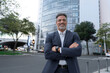 © Stock 4 You - Smiling confident latin hispanic mature business man standing crossed arms on busy city street. Proud portrait of older senior businessman professional ceo, coach, leader looking at camera near office