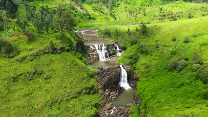 Wall Mural - Aerial drone ofwaterfall in the mountains and tea plantation. St. Clair Falls, Sri Lanka