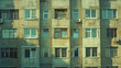 Sunlit facade of a weathered post-Soviet apartment building