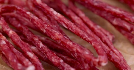 Wall Mural - Thin dehydrated meat close-up, dry pork meat on the table