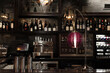 Boutique wine bar styled with a plush plum glass floor lamp with nickel accents.