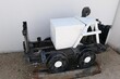 Small white painted vintage railroad vehicle used for narrow railroad tracks in sea salt production factory, displayed as exhibit. 