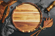 Kitchen wooden tray or board on a dark stone background. Top view. Free space for text.