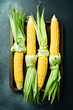Organic raw corn on a metal tray. Yellow corn cobs. Organic food. Top view.