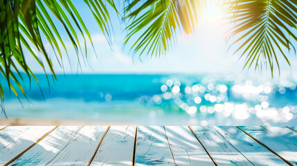 Wall Mural - Tropical beach view with sun gleaming through green palm leaves, showcasing a serene ocean and clear blue sky, viewed from a white wooden deck.