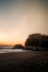 Canvas Print - Rocky beach at sunset with colorful sky