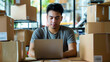 © Creative Valley - Man Running Small Business from Home with Laptop and Phone