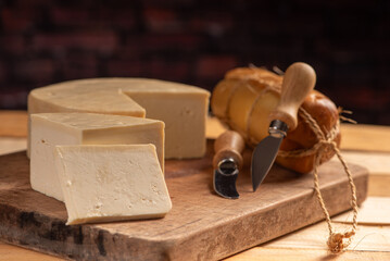 Cheese, details of beautiful and delicious cheese on rustic wooden surface, selective focus.