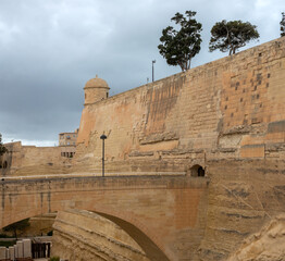 Wall Mural - Old bridge and gate in the historic city walls of the fortified old town of Valletta (Il-Belt) the capital of Malta