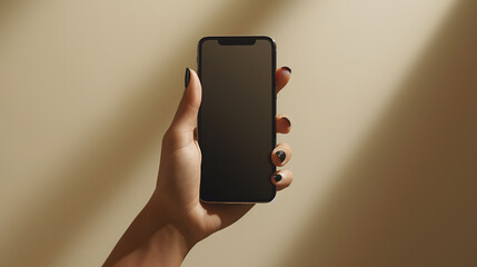 hand holding smartphone with black screen against warm background