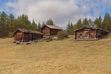 Smoke sauna, Huhti-Heikki´s hut and Jooseppi`s hut at Raja-Jooseppi homestead  located on the banks of Luttojoki river in spring, Lapland, Finland.