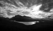 A black and white image of the views of the summit of Beinn Airigh Charr in the distance and Aird Mhor closer to the camera with Loch Kernsary in the foreground.