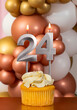 Cupcake with birthday candle on balloons background - Number 24