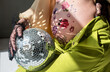 pregnant woman with belly in flower patterns, light reflection and playing disco ball