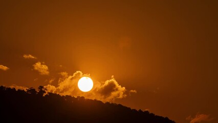 Wall Mural - timelapse of dramatic sunrise with orange sky in a sunny day.