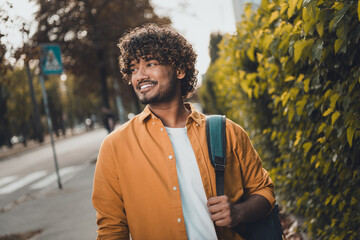 Canvas Print - Photo of cheerful indian man wearing stylish clothes going home after college lectures nice sunny weather outside