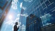 © Mustafa - Businessman using mobile phone to talk business in office. View from the outside 3D rendering commercial skyscraper
