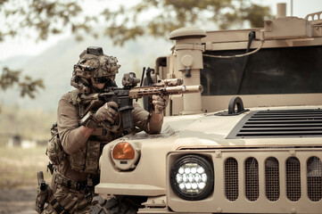 Wall Mural - United States Army in camouflage uniforms operation in the forest.with armored vehicle, soldiers training  in a military operation