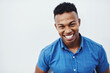 © peopleimages.com - Happy, portrait and funny man laughing in studio with mockup, positive attitude and feel good mood or confidence on white background. Comic, face and African model smile for goofy joke or comedy