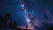 A person stands in front of a mountain range, looking up at the night sky