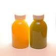 Fresh Yellow Fruit and Green Vegetable Juice in Plastic Bottles