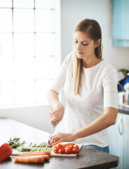 Wall Mural - Woman, kitchen and cutting in vegetables, healthy and cooking at home, meal prep and nutrition. Vegetarian, organic and ingredients with food, diet and wellness or dinner, lunch in apartment