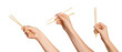 © Marina Red - A set of female hands holding wooden chopsticks for sushi or rolls on a blank background.