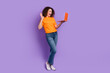 © deagreez - Full length photo of positive adorable woman manager wear trendy clothes speak online wave arm say hi isolated on purple color background