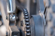 Close up view of the motorcycle drive chain on a wheel. Vehicle, transport and machinery concepts