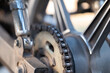 Motorcycle drive chain on a wheel, close up. Concepts of vehicle, transport and machinery