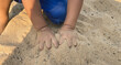 Playing with sand in the playground with hands small hand muscles large muscles of young children at an age when their bodies are growing and becoming strong according to childhood