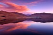 This serene landscape captures the enchanting moment of sunset with smooth transitions of purple and orange hues painting the sky