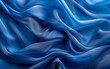 © munja02 - Colorful background of flowing blue fabric. Smooth and soft.