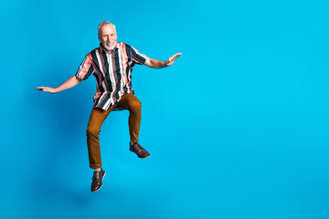 Poster - Photo of cheerful glad good mood senior man wear striped stylish clothes blank space isolated on blue color background